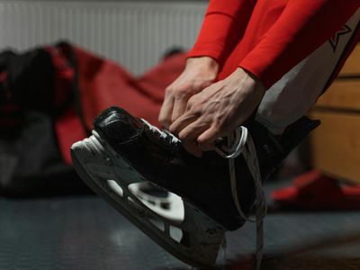 Man tying shoelaces before a strength training session